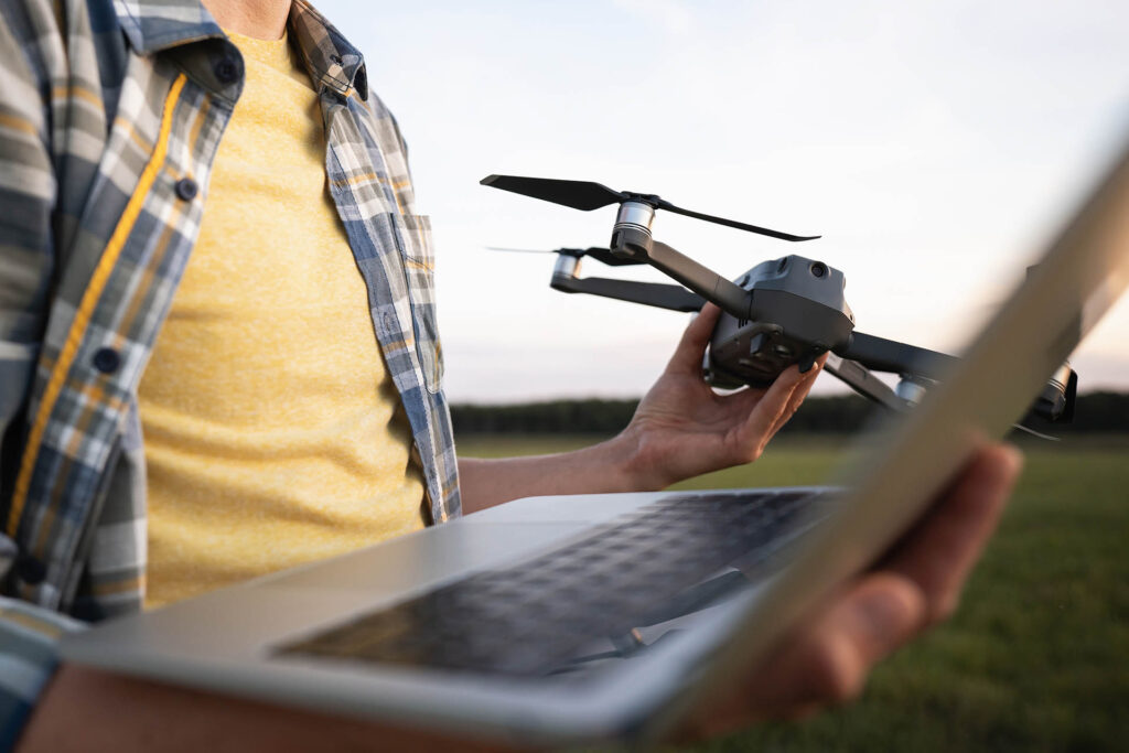 Farmer,With,Laptop,And,Drone,On,The,Field.,Smart,Farming